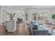 Open-concept living space with hardwood floors, dining area, and large windows providing plenty of natural light at 421 Raven Cliff St, Apex, NC 27523