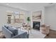 Bright living room featuring a fireplace, plush seating, and a large window with neighborhood views at 421 Raven Cliff St, Apex, NC 27523