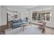 Cozy living room featuring a couch, accent chair, and views of the backyard at 421 Raven Cliff St, Apex, NC 27523