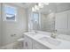 Bright bathroom featuring a double vanity and a view into the shower area at 4897 Grosbeak Ct, Mebane, NC 27302