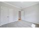Bedroom featuring carpet, neutral colored walls, and a double door closet at 4897 Grosbeak Ct, Mebane, NC 27302