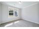 Bedroom with new carpet and a view of the outdoors through the window at 4897 Grosbeak Ct, Mebane, NC 27302