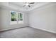 Bedroom with neutral carpet, tray ceiling and a large window that offers serene views at 4897 Grosbeak Ct, Mebane, NC 27302