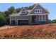 Charming craftsman-style home features a two-car garage, stone accents, and a welcoming covered porch at 4897 Grosbeak Ct, Mebane, NC 27302