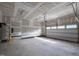 Spacious garage featuring an automatic door, utility sink, water heater, and ample unfinished wall space at 4897 Grosbeak Ct, Mebane, NC 27302