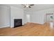 Spacious living room features hardwood floors, a decorative fireplace, and large windows at 4897 Grosbeak Ct, Mebane, NC 27302