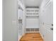 Hallway with a mudroom area features a bench, built-in shelves, and hardwood floors at 4897 Grosbeak Ct, Mebane, NC 27302