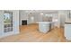 Open-concept kitchen and living room with hardwood floors, fireplace, and stainless appliances at 4897 Grosbeak Ct, Mebane, NC 27302