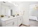 Bathroom with double vanity, tile flooring and modern lighting at 509 Rose Creek Ct, Zebulon, NC 27597