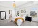Bright bedroom with en suite bathroom, tray ceiling and neutral carpet at 509 Rose Creek Ct, Zebulon, NC 27597
