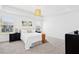 Bright bedroom with tray ceiling, black nightstands and neutral carpet at 509 Rose Creek Ct, Zebulon, NC 27597