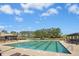 Large community pool with clear blue water, surrounded by lounge chairs and lush greenery, perfect for relaxation and recreation at 509 Rose Creek Ct, Zebulon, NC 27597
