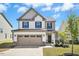 Charming two-story home with a two-car garage, well-manicured lawn, and neutral color scheme at 509 Rose Creek Ct, Zebulon, NC 27597