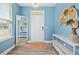 Light and bright foyer with wood floors, a large mirror, and decorative wall hangings at 509 Rose Creek Ct, Zebulon, NC 27597