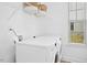 Bright laundry room featuring a modern LG washer and dryer set, overhead wire shelving, and a well-lit window at 509 Rose Creek Ct, Zebulon, NC 27597