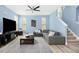 Spacious living room with a large sectional sofa and modern decor at 509 Rose Creek Ct, Zebulon, NC 27597
