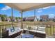 Cozy screened porch furnished with comfortable seating, throw pillows, and a view of the green backyard and neighborhood at 509 Rose Creek Ct, Zebulon, NC 27597