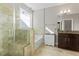 Well-lit bathroom with a glass shower, soaking tub, and granite vanity, offering a spa-like retreat at 5417 Razan St, Raleigh, NC 27616