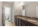 Dual sink bathroom with granite counters and updated fixtures provides modern functionality and style at 5417 Razan St, Raleigh, NC 27616