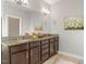 Spacious bathroom featuring a double vanity, granite countertops, and ample storage space at 5417 Razan St, Raleigh, NC 27616