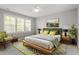 Bright bedroom boasts a large window, stylish furniture, and vibrant accents for a modern look at 5417 Razan St, Raleigh, NC 27616