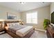 Warm bedroom with ample natural light, a large bed, and modern decor for a cozy retreat at 5417 Razan St, Raleigh, NC 27616