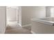 Hallway with neutral walls, plush carpeting, white trim, and paneled doors at 5417 Razan St, Raleigh, NC 27616