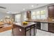 Well-designed kitchen with a center island, stainless steel appliances, and modern countertops at 5417 Razan St, Raleigh, NC 27616