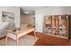 Well-lit home office with a modern desk, stylish bookcase, and hardwood floors for a productive workspace at 5417 Razan St, Raleigh, NC 27616
