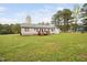 Expansive backyard featuring a wooden deck and lush green lawn, perfect for outdoor enjoyment at 545 Irvan St, Clayton, NC 27520