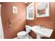 A full bathroom featuring neutral tiling, white porcelain fixtures, and a standard showerhead at 545 Irvan St, Clayton, NC 27520