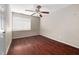 Bedroom featuring hardwood floors, a ceiling fan, and a window with blinds for natural light at 545 Irvan St, Clayton, NC 27520