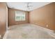 Bedroom featuring a ceiling fan and a window with blinds to let natural light in, ideal for customization at 545 Irvan St, Clayton, NC 27520