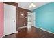 A bedroom featuring wood floors, a door, and a view to another room at 545 Irvan St, Clayton, NC 27520