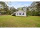 A lovely yard surrounds this single-story home with purple shutters and siding at 545 Irvan St, Clayton, NC 27520