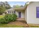 Inviting entrance with a vibrant front door and manicured shrubbery at 545 Irvan St, Clayton, NC 27520