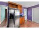 A kitchen features stainless steel refrigerator, wood cabinets, and an adjacent door at 545 Irvan St, Clayton, NC 27520