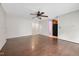 Living room featuring hardwood floors, a ceiling fan, and an open doorway leading to an adjoining room at 545 Irvan St, Clayton, NC 27520