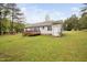 Exterior shot of the home's rear featuring a deck and siding at 545 Irvan St, Clayton, NC 27520