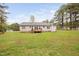 Exterior shot of the home's rear and large backyard featuring a deck at 545 Irvan St, Clayton, NC 27520