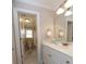 Well-lit bathroom with a white vanity, large mirror, and a glimpse of the toilet and shower at 5515 S Roxboro St # 16, Durham, NC 27713