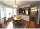 Open dining area with hardwood floors, bay window, and adjacent kitchen, perfect for entertaining at 5515 S Roxboro St # 16, Durham, NC 27713