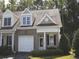 Charming townhome featuring a brick facade, attached garage, and well-maintained landscaping at 5515 S Roxboro St # 16, Durham, NC 27713