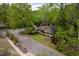 Aerial view showcases the home, nestled among lush trees, creating a serene and private setting at 5816 Old Forge Cir, Raleigh, NC 27609