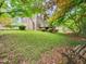 A spacious backyard with lush greenery, mature trees, and a wooden deck provides a private outdoor retreat at 5816 Old Forge Cir, Raleigh, NC 27609