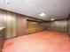 Spacious finished basement with wood paneling, neutral carpeting, and ample room for a variety of uses at 5816 Old Forge Cir, Raleigh, NC 27609