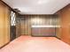 A finished basement featuring wood paneling, wet bar, and updated lighting, ideal for entertaining at 5816 Old Forge Cir, Raleigh, NC 27609