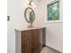 Bathroom with a curved wooden vanity, patterned tile floor, and neutral walls at 5816 Old Forge Cir, Raleigh, NC 27609