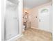 Cozy bathroom with tiled floor and vanity, next to a glass-door shower and front door at 5816 Old Forge Cir, Raleigh, NC 27609
