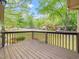 Outdoor wooden deck showcasing mature trees, lush surroundings, and neighborhood views at 5816 Old Forge Cir, Raleigh, NC 27609